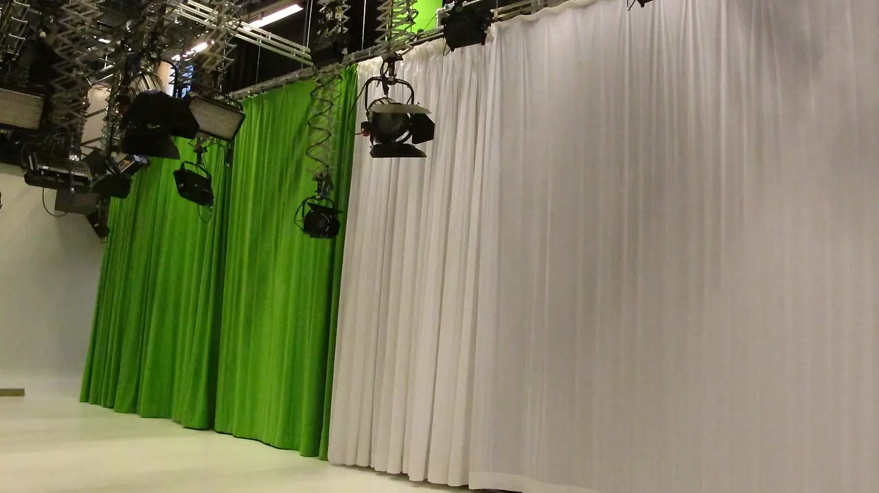 White and green studio perimeter drapes on curtain track