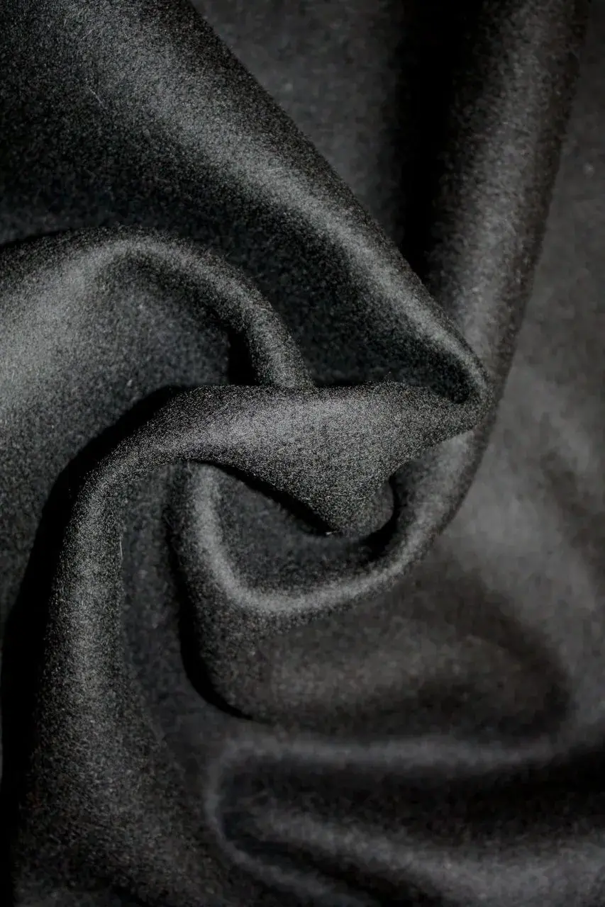 Matte black wool serge masking fabric with a dense, non-reflective weave.