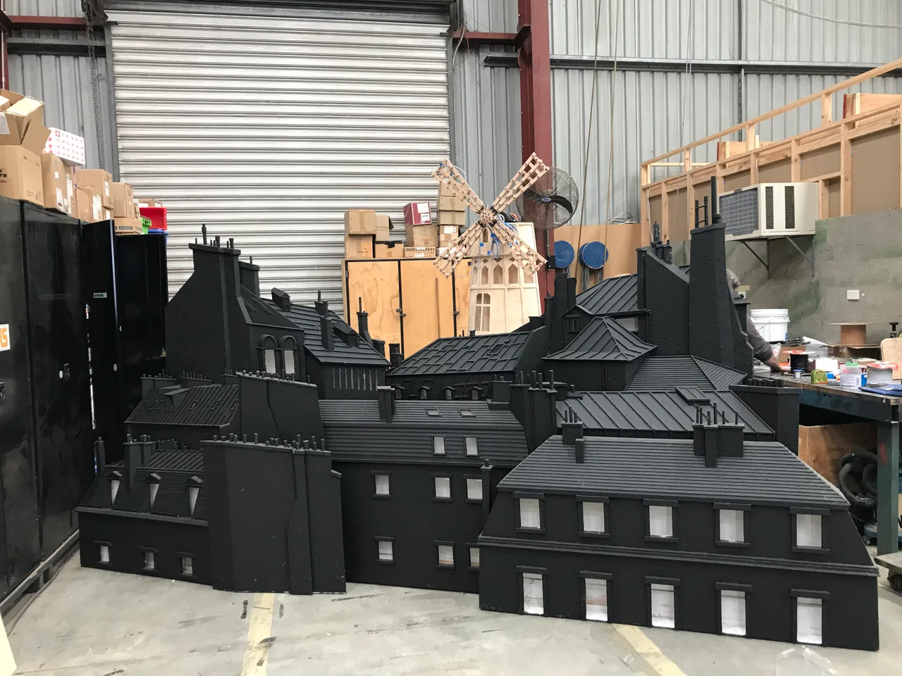 Parisian rooftop set pieces lined up in the scenic workshop