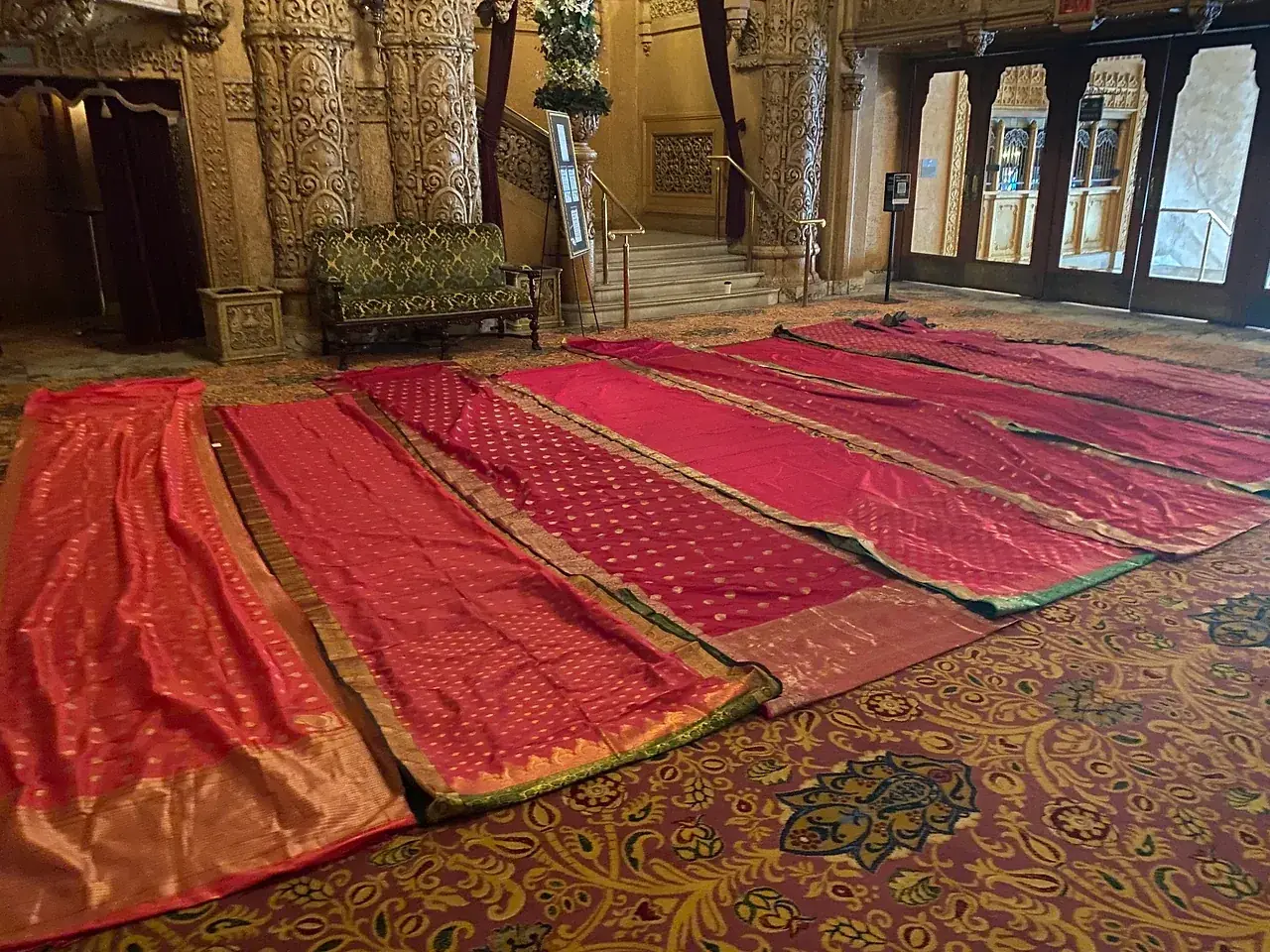 Reveal team laying out saree fabric in the Regent Theatre foyer during pre-production. Photo: Reveal Productions.