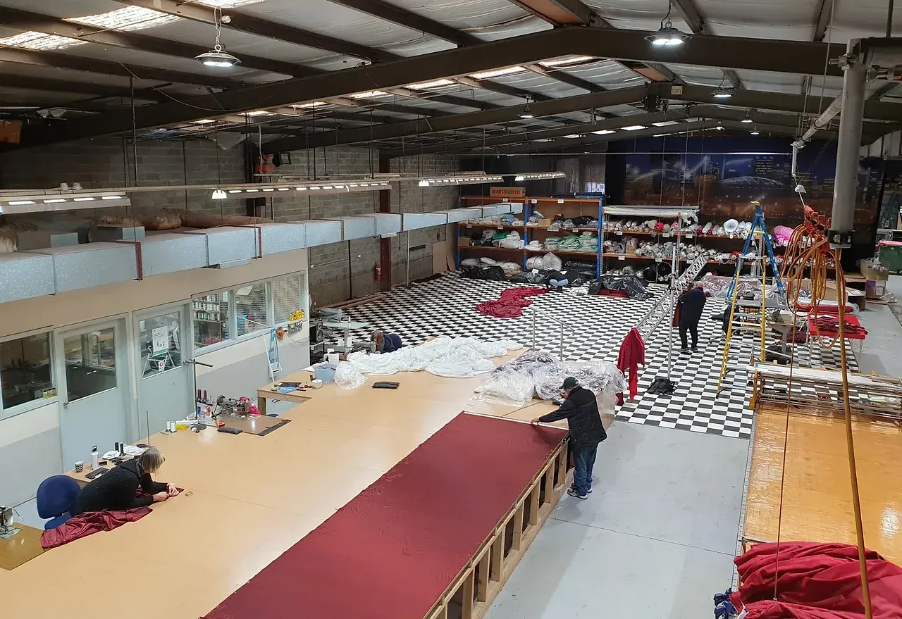 Reveal Productions sewing line preparing long lengths of red velvet for Moulin Rouge drapery. Photo: Reveal Productions.