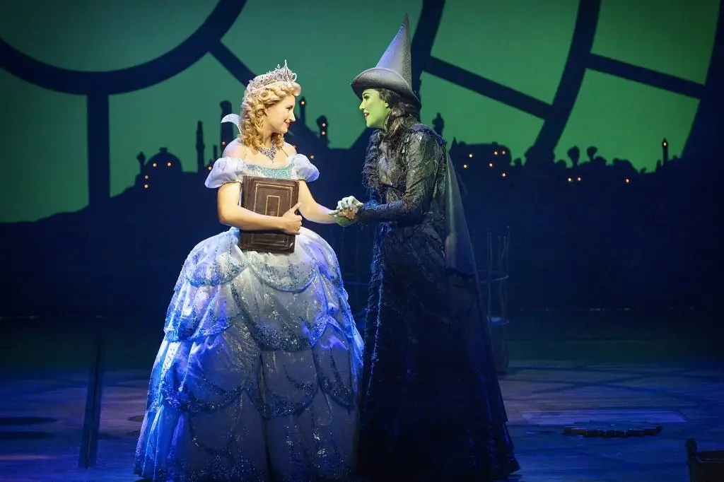 Glinda and Elphaba before the Emerald City skyline. Photo: Jeff Busby.