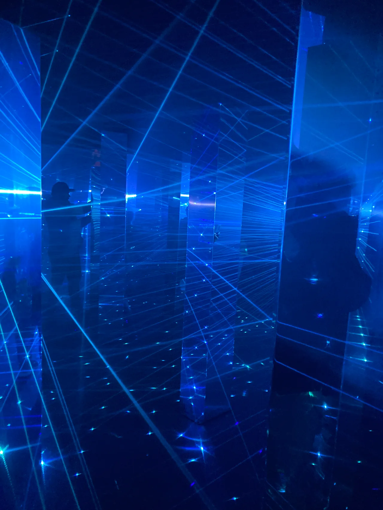 Visitors inside a mirrored laser maze installation at Illuminate Adelaide