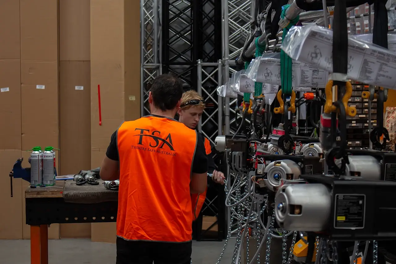 TSA technicians assembling EXE Rise chain hoists in the workshop