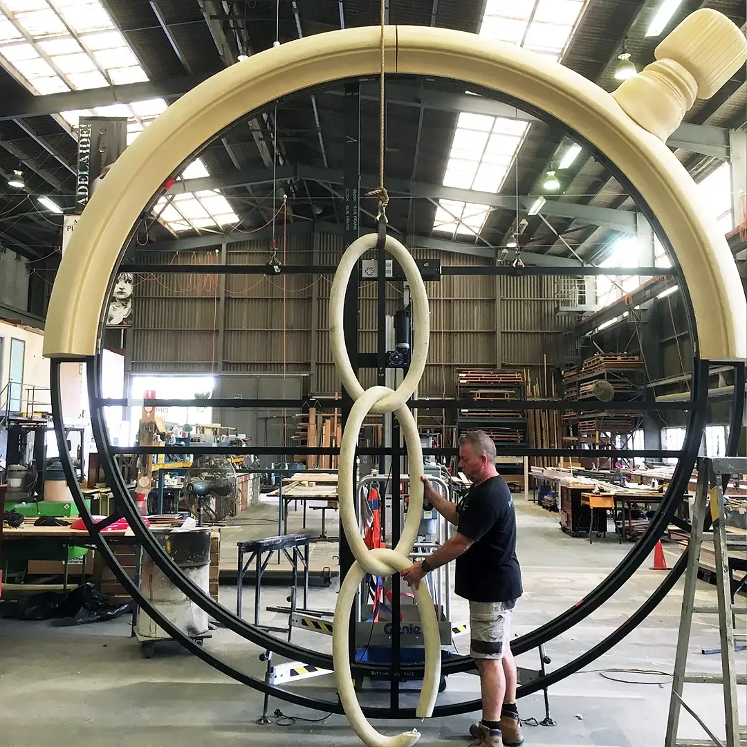 A giant scenic ring and chain links rigged for a lift in the workshop